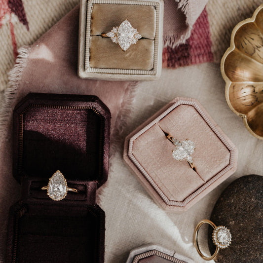 Affordable engagement rings in different styles displayed in velvet jewelry boxes