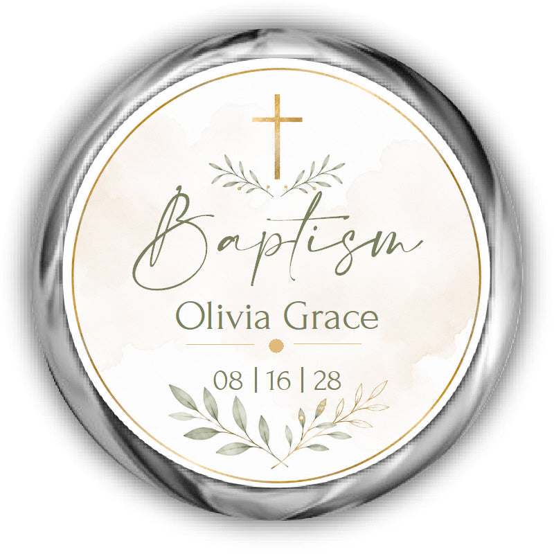 A round baptism label or sticker with a metallic silver border, featuring a gold cross on a light cream watercolor background.