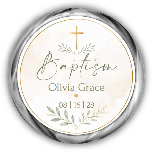 A round baptism label or sticker with a metallic silver border, featuring a gold cross on a light cream watercolor background.