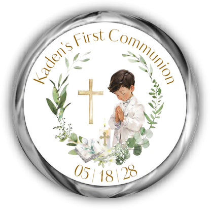First Communion Kisses Stickers, boy with brunette hair and tan skin surrounded by a eucalyptus wreath, a bible, candle and cross.