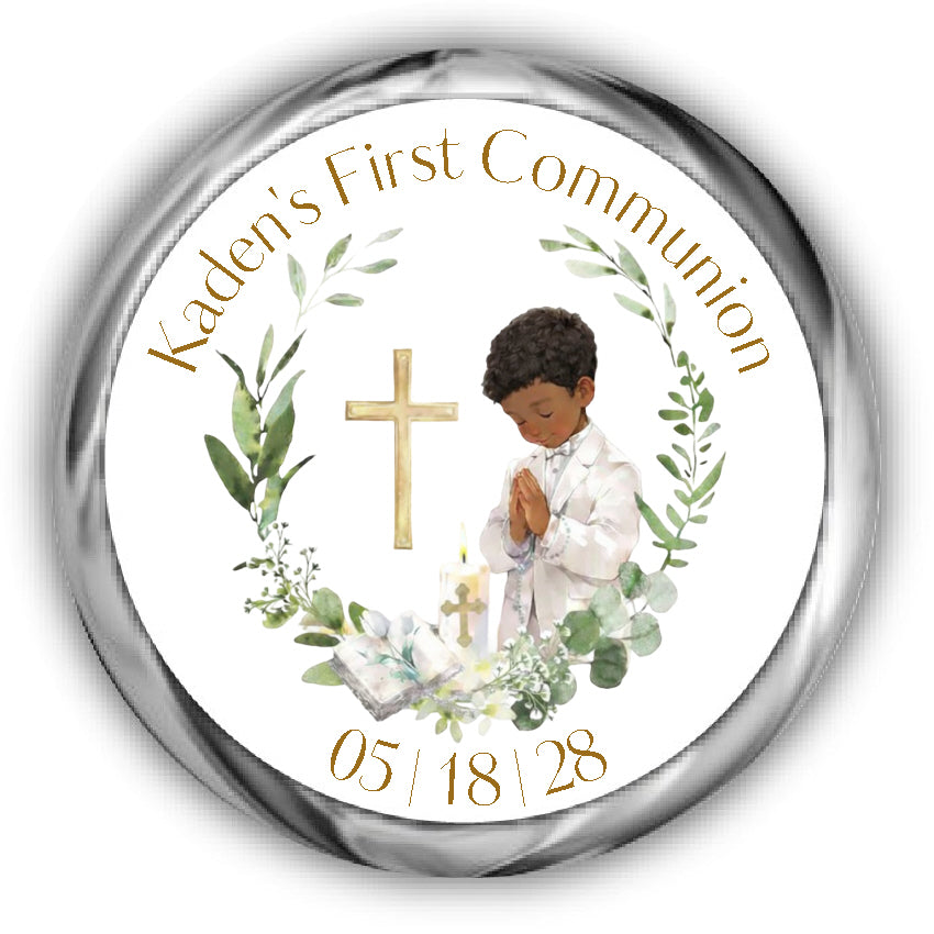 A First Communion Kisses Stickers, boy with curly hair and tan skin surrounded by a eucalyptus wreath, a bible, candle and cross.